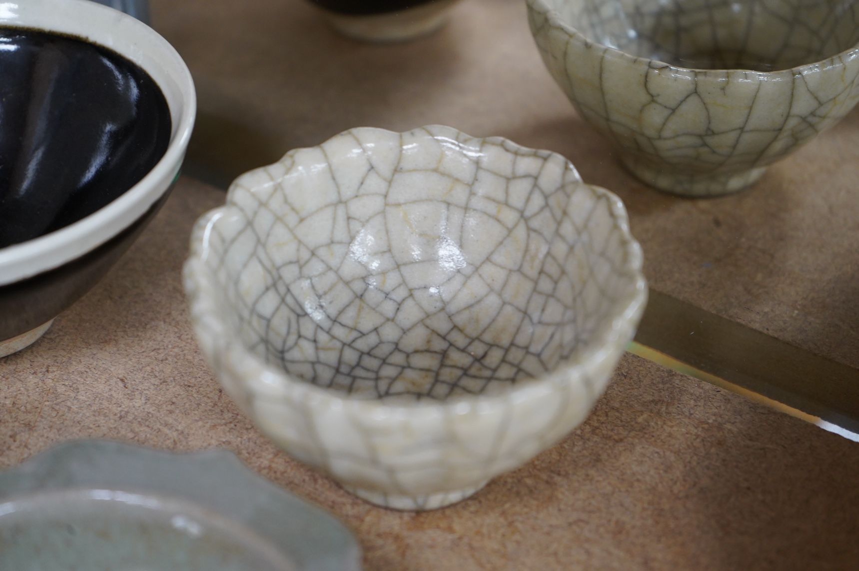 A collection of Chinese porcelain and pottery to include a naturalistic teapot, crackle glaze bowl and a ‘dragon’ bowl, largest 10cm in diameter